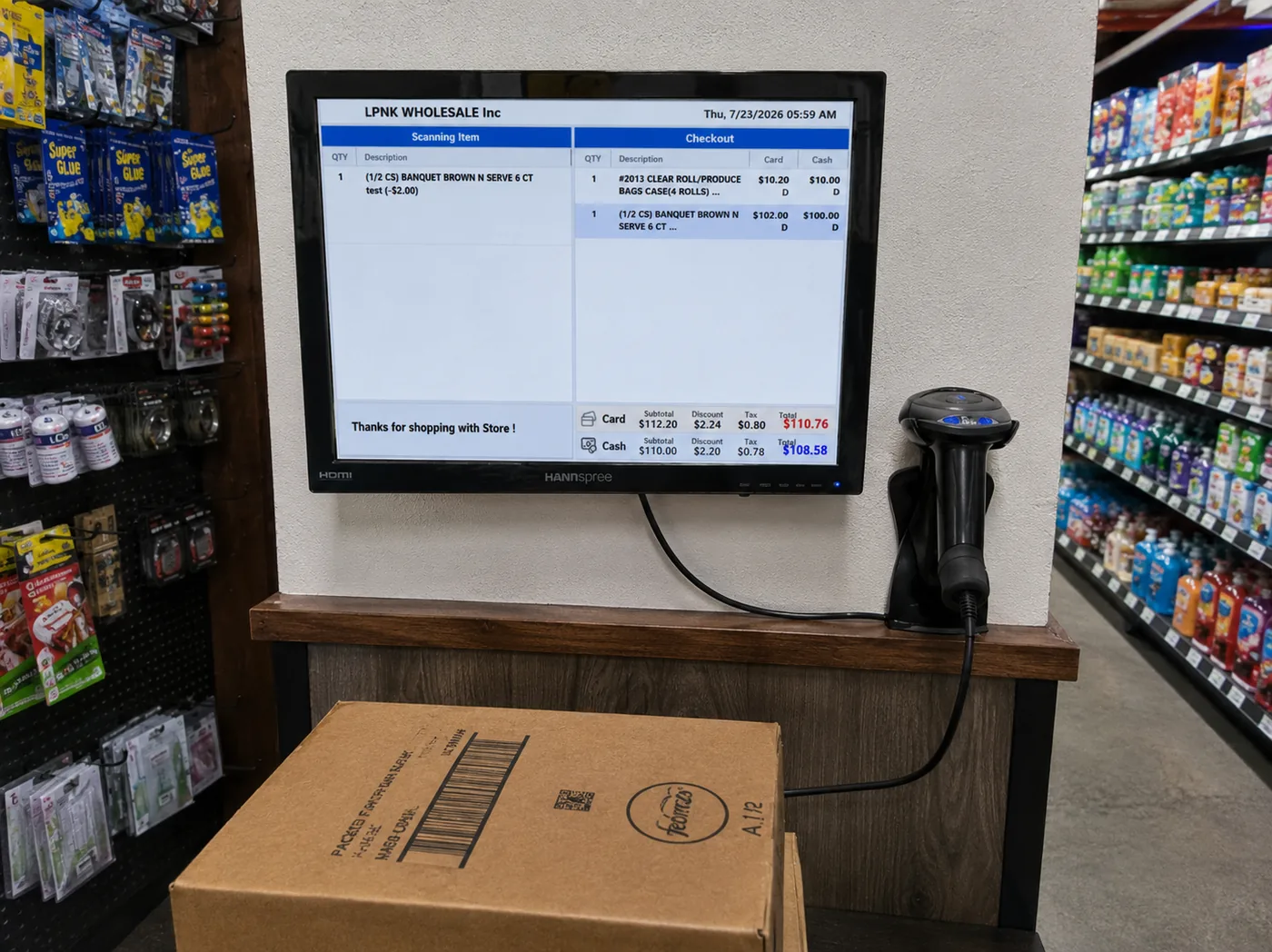 A wall-mounted price check screen showing a live checkout total in a grocery aisle